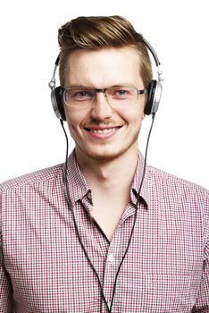 Young man listens to music and smiles with headphones.