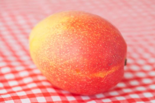 mango fruit on checkered fabric