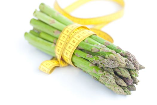 asparagus tied with measuring tape isolated on white