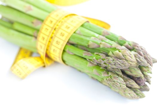 asparagus tied with measuring tape isolated on white