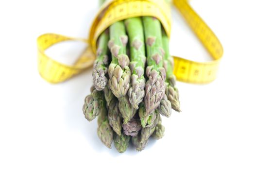 asparagus tied with measuring tape isolated on white