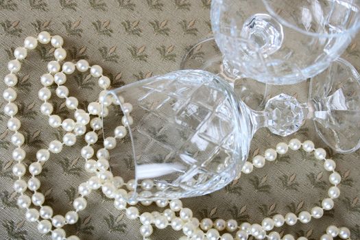 String of pearls and crystal wine glasses