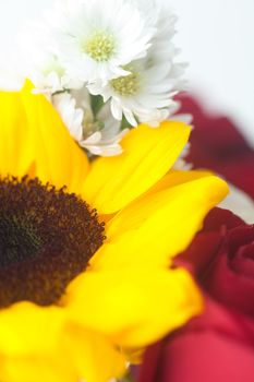 bouquet of red roses and sunflower in a vase 