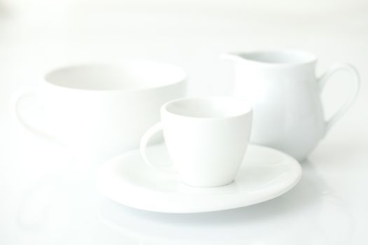 white cup with saucer and milk jug 