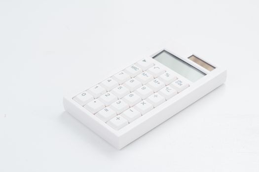 White calculator on the white table