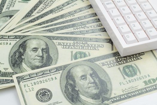 US bank note and calculator on white background