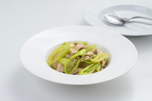 pork fried with sweet pepper. Thai food on white dish