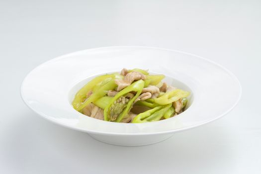 pork fried with sweet pepper. Thai food on white dish