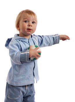 Little boy holding soccer ball and point out