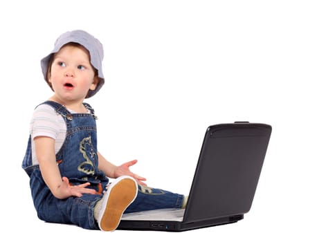 Little boy sitting with a laptop isolated on the white