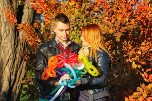 Young couple tenderly and lovingly looking at each other in autumn park