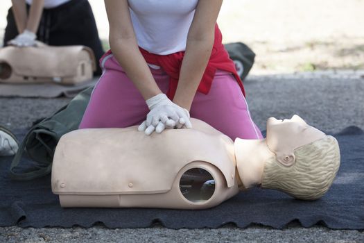 Paramedic demonstrates CPR on dummy