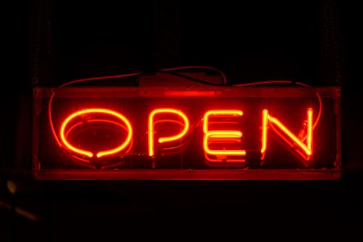 Red open neon sign in the night