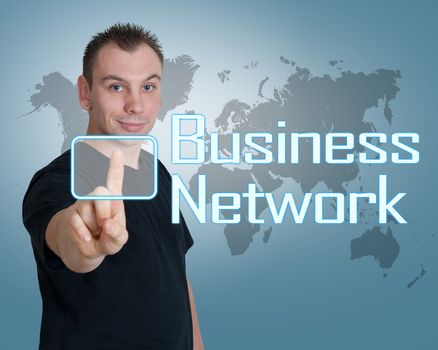 Young man press digital Business Network button on interface in front of him