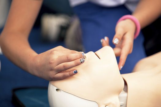 Paramedic demonstrates CPR on dummy