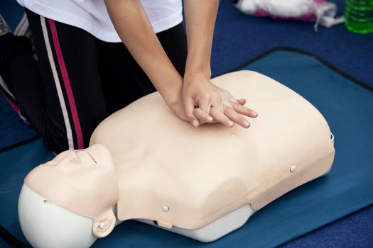 Paramedic demonstrates CPR on dummy