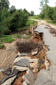 Collapse of the paved road in the forest.