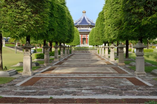 Path in Chinese garden style leading to a pavilion