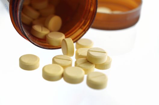 pills an pill bottle on white background