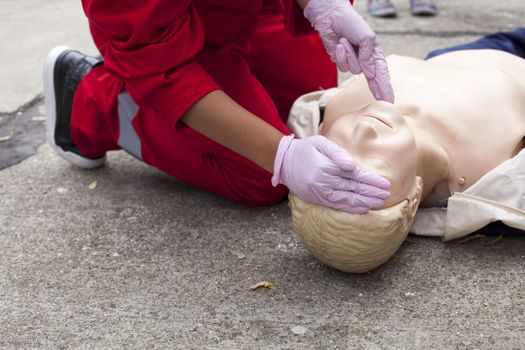 Paramedic demonstrates CPR on dummy