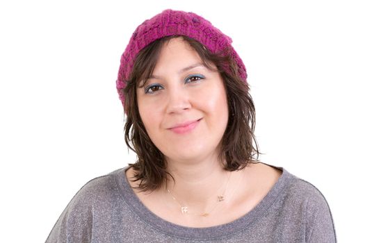 Happy attractive young woman with a charming smile wearing a purple knitted beanie, head and shoulders on white