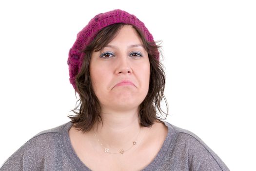 Supercilious disdainful woman in a knitted purple beanie sneering at the camera with a scornful look, head and shoulders on white
