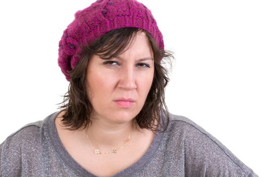 Woman frowning in disbelief with an assessing look peering at the camera with a calculating expression as she tries to fathom the truth, isolated on white