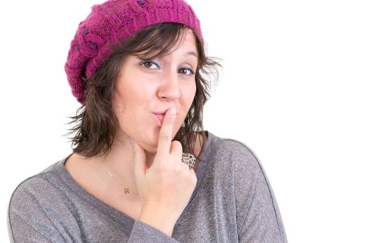 Distrustful sceptical woman with misgivings looking at the camera with a thoughtful assessing look and her finger to her lips, isolated on white