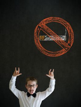 Knowledge rocks boy dressed up as business man with no smoking chalk sign on blackboard background