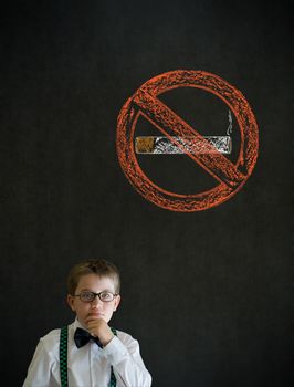 Thinking boy dressed up as business man with no smoking chalk sign on blackboard background