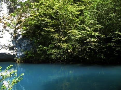 Little blue lake in the middle of the caucasus mountains