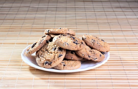 Some cookies on the plate at the textured background