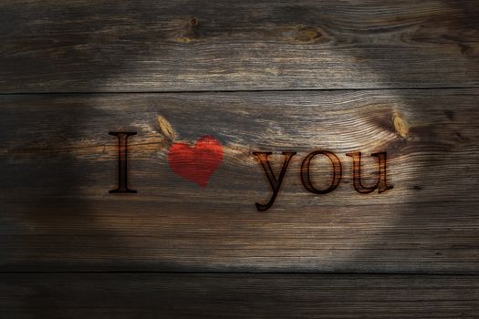 The old plank of spent inscription I love you, a Valentines Day theme.