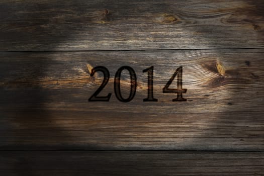 The old plank of spent inscription 2014, a  New Year background.