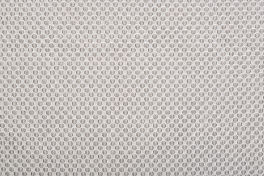 The beige fabric with dots, a textile background.