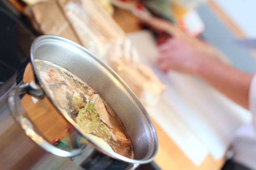 Stell saucepan with soup at the kitchen