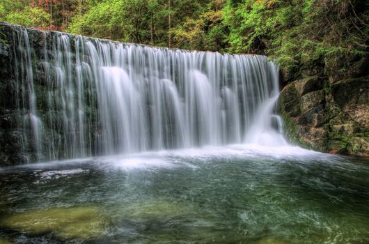 Awesome wide waterfall in summer / mossy rock and forest