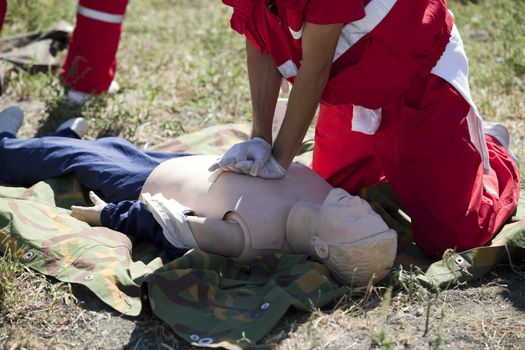 Paramedic demonstrates CPR on dummy