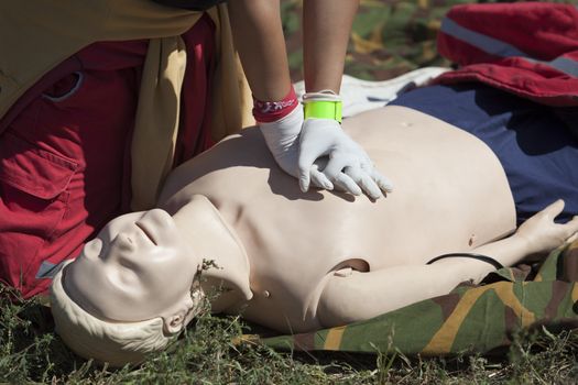 Paramedic demonstrates CPR on dummy