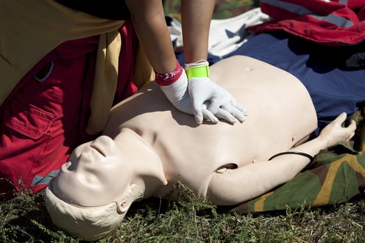 Paramedic demonstrates CPR on dummy