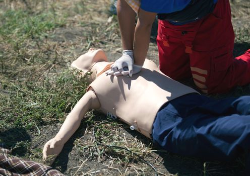 Paramedic demonstrates CPR on dummy