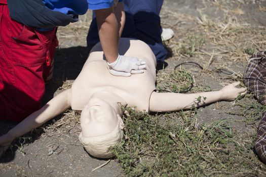 Paramedic demonstrates CPR on dummy