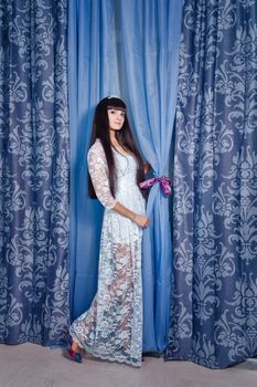 Attractive young girl in evening dress with tiara on her head