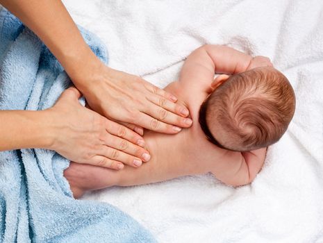 Masseuse massaging 5 months infant