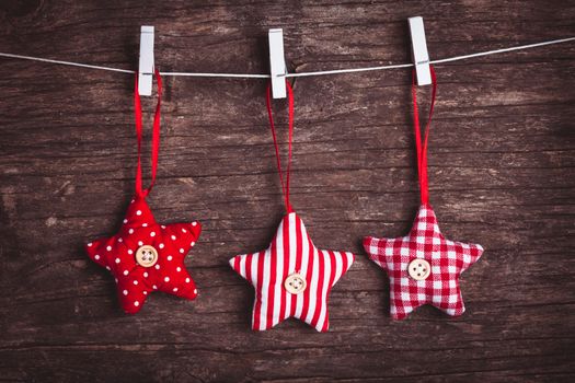 White and red sewed christmas stars attached to the rope