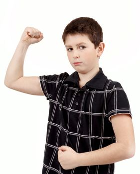 Portrait of a young boy with hand raised up and showing its own muscles against white background