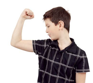 Portrait of a young boy with hand raised up and showing its own muscles against white background