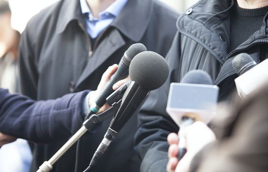 A journalist is making a interview with a microphone