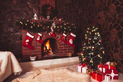 Christmas decorated fireplace and tree in the room