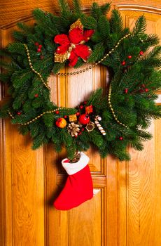 Christmas wreath with red sock on the door